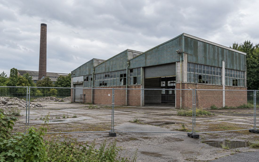 Disused industrial building fenced off ready for demolition